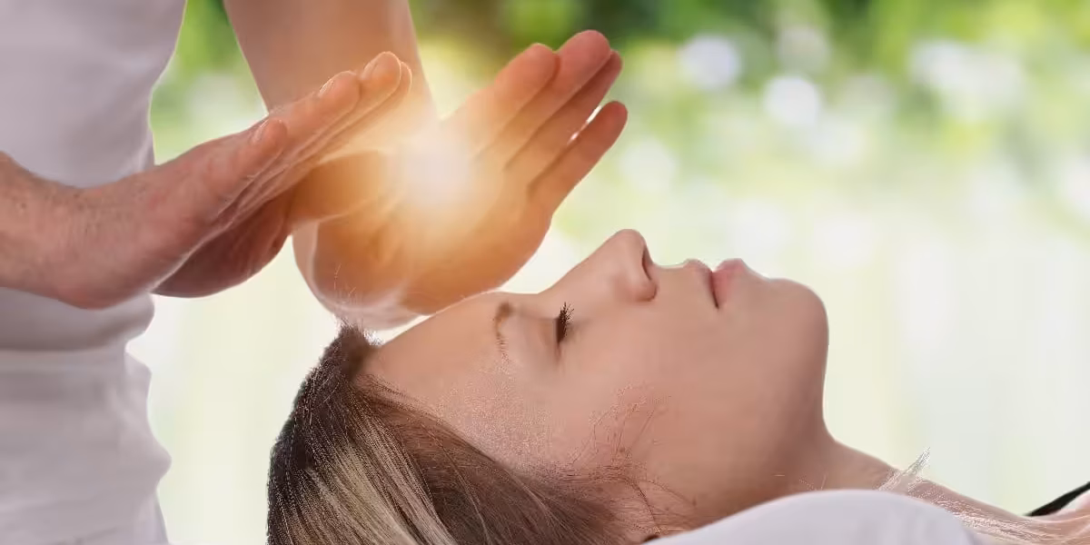 Woman having reiki healing treatment , alternative medicine concept.